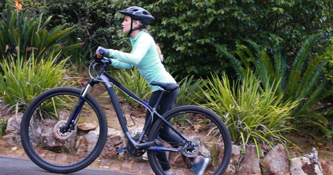 Woman Enjoying Leisurely Bike Ride in Park - Free Images, Stock Photos and Pictures on Pikwizard.com