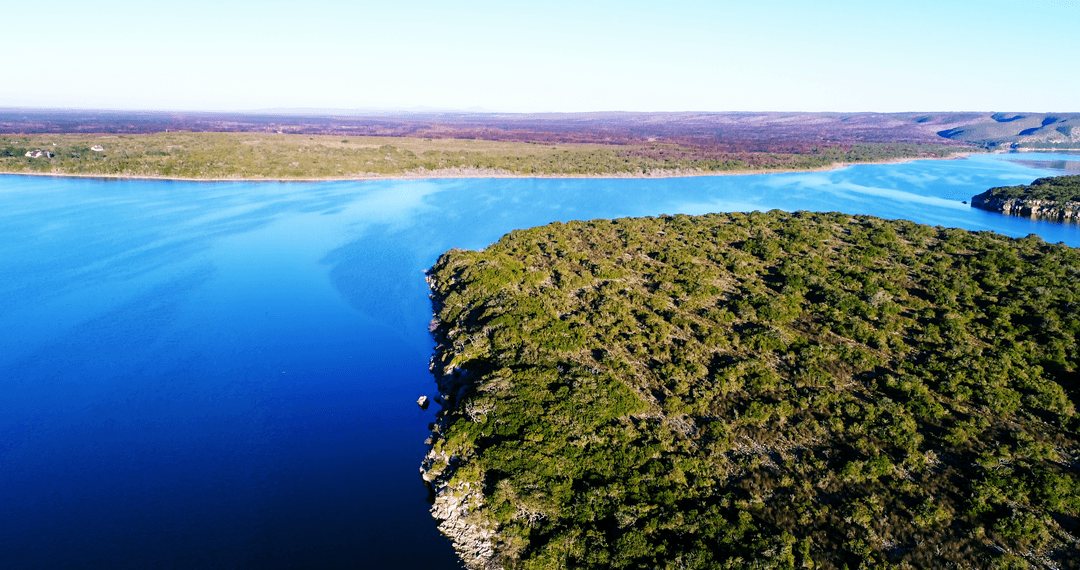 Transparent Blue River Winding Through Lush Landscapes