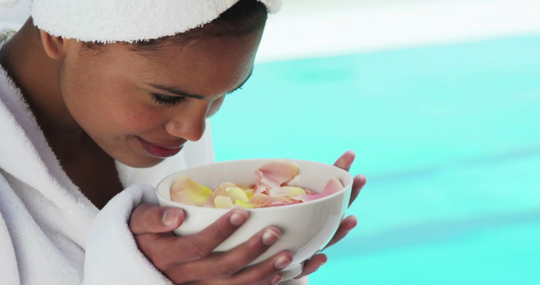 Woman Relaxing with Aromatic Petals in Spa Setting by Pool - Free Images, Stock Photos and Pictures on Pikwizard.com