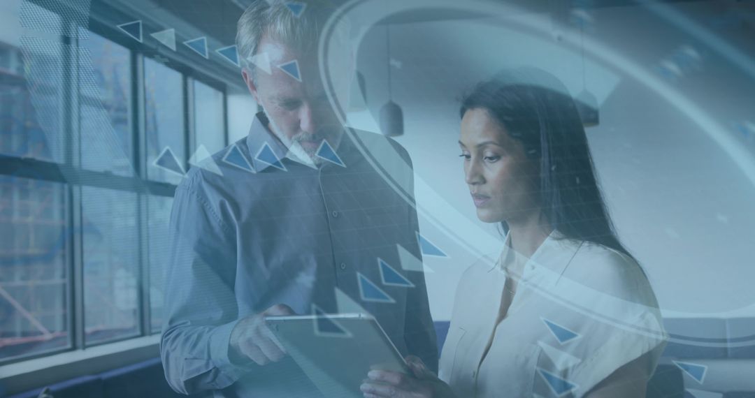 Business colleagues reviewing tablet with augmented reality data overlay and dashboards