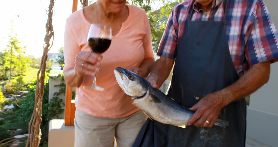 Seniors with Freshly Caught Fish Celebrating Outdoors - Free Images, Stock Photos and Pictures on Pikwizard.com