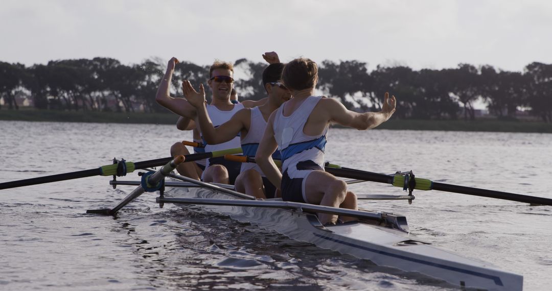 Team of Rowers Celebrating Victory in Rowing Competition on Lake - Free Images, Stock Photos and Pictures on Pikwizard.com