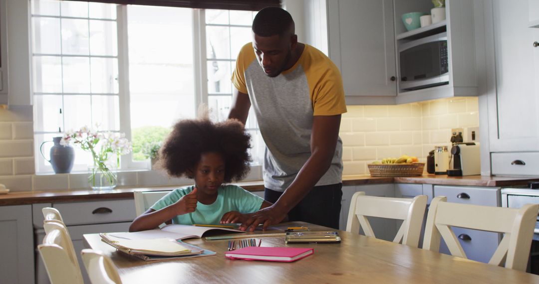 African American Father Helping Daughter with Home School Work During Quarantine - Free Images, Stock Photos and Pictures on Pikwizard.com