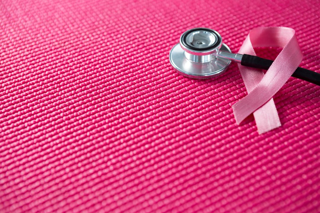 High angle view of pink Breast Cancer Awareness ribbon with stethoscope - Free Images, Stock Photos and Pictures on Pikwizard.com