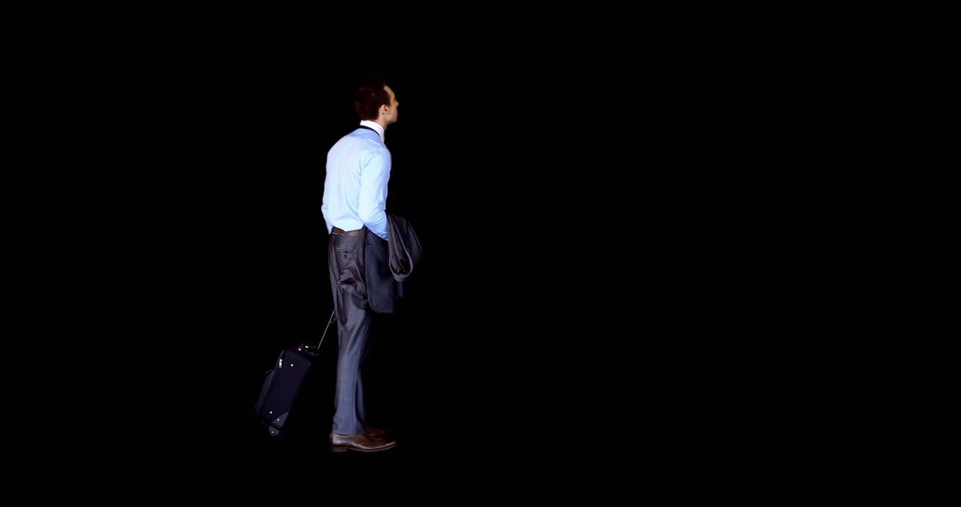 Businessman with Luggage Looking Forward in Black Background - Free Images, Stock Photos and Pictures on Pikwizard.com