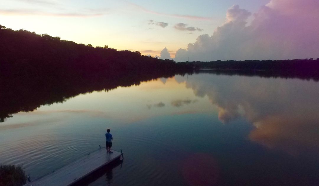 Solitary Angler on Lake Dock at Sunset - Free Images, Stock Photos and Pictures on Pikwizard.com