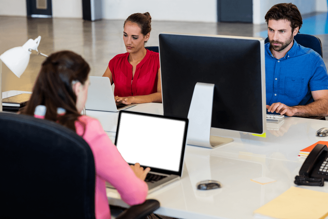 Colleagues Collaborating in Modern Office Space with Transparent Desks