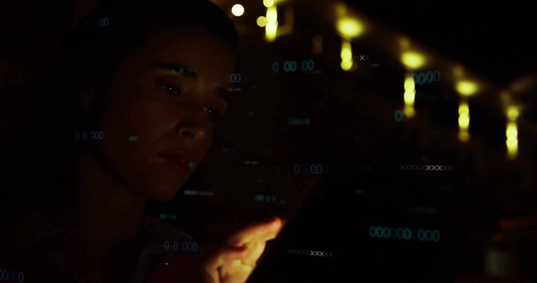 Woman Engaging with Touchscreen Device in Low Light Setting