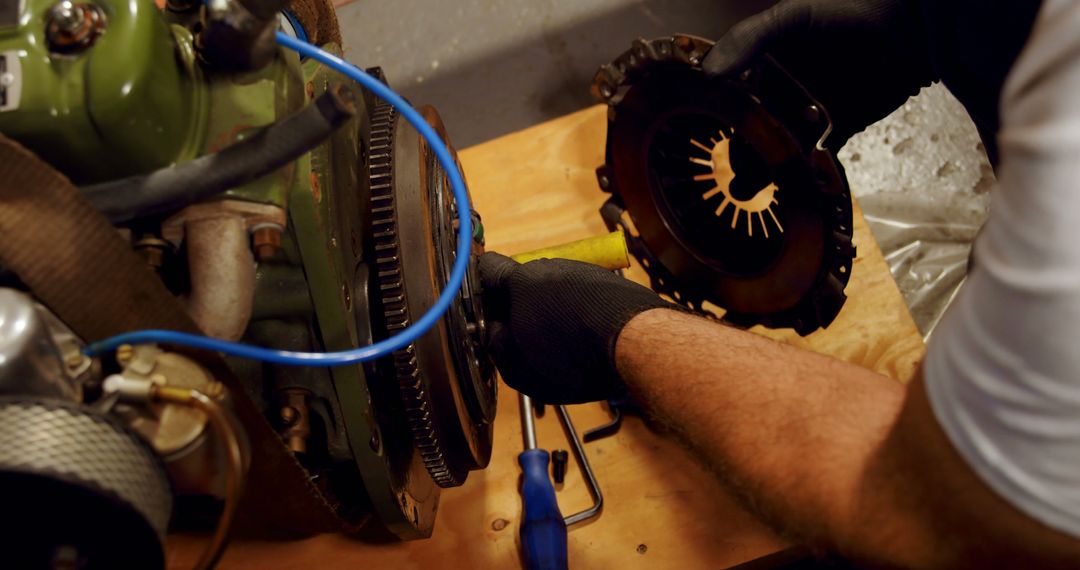 Mechanic Repairing Engine Clutch on Workbench - Free Images, Stock Photos and Pictures on Pikwizard.com