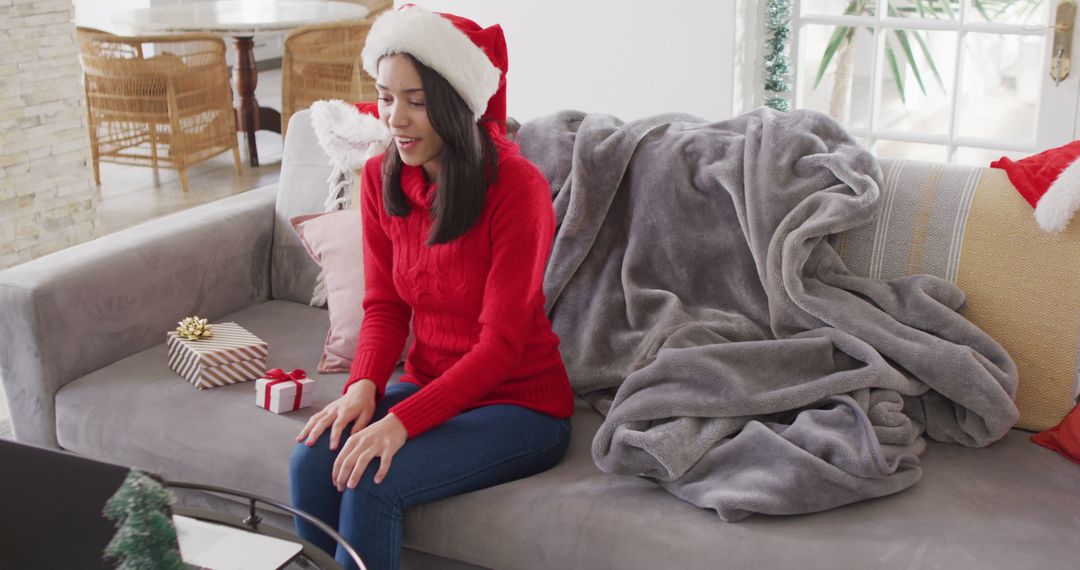 Biracial woman with santa hat having image call - Free Images, Stock Photos and Pictures on Pikwizard.com