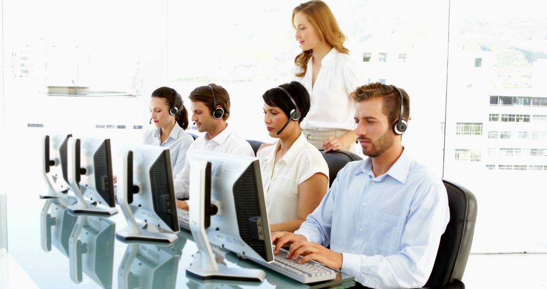 Supervisor Overseeing Busy Call Center Team in Office Environment
