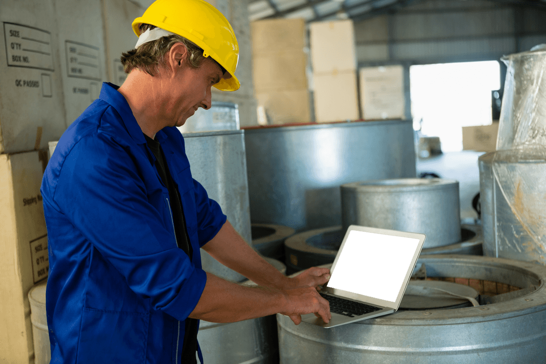 Worker Using Transparent Laptop in Industrial Factory Setting