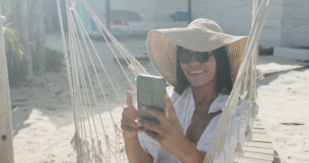 Woman Relaxing in Hammock Using Smartphone at Beach - Free Images, Stock Photos and Pictures on Pikwizard.com