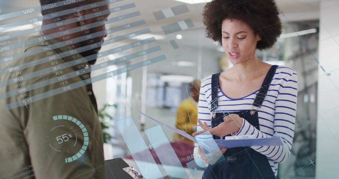 Colleagues Discussing Data and Diagrams in Modern Office Environment