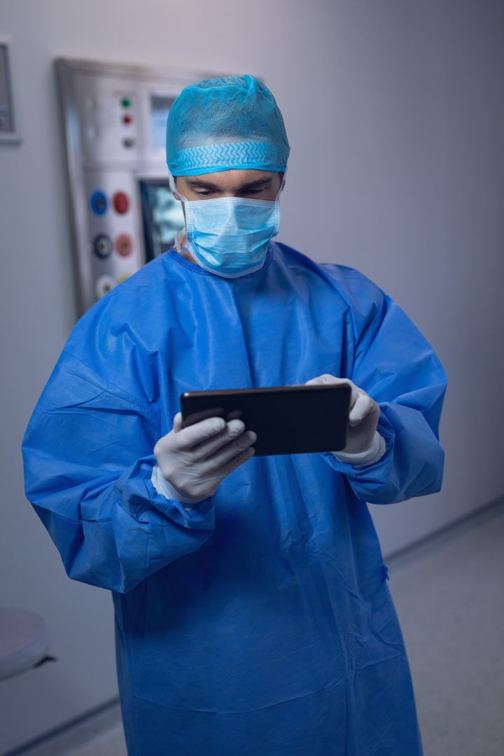 Male surgeon using digital tablet in operating room - Free Images, Stock Photos and Pictures on Pikwizard.com