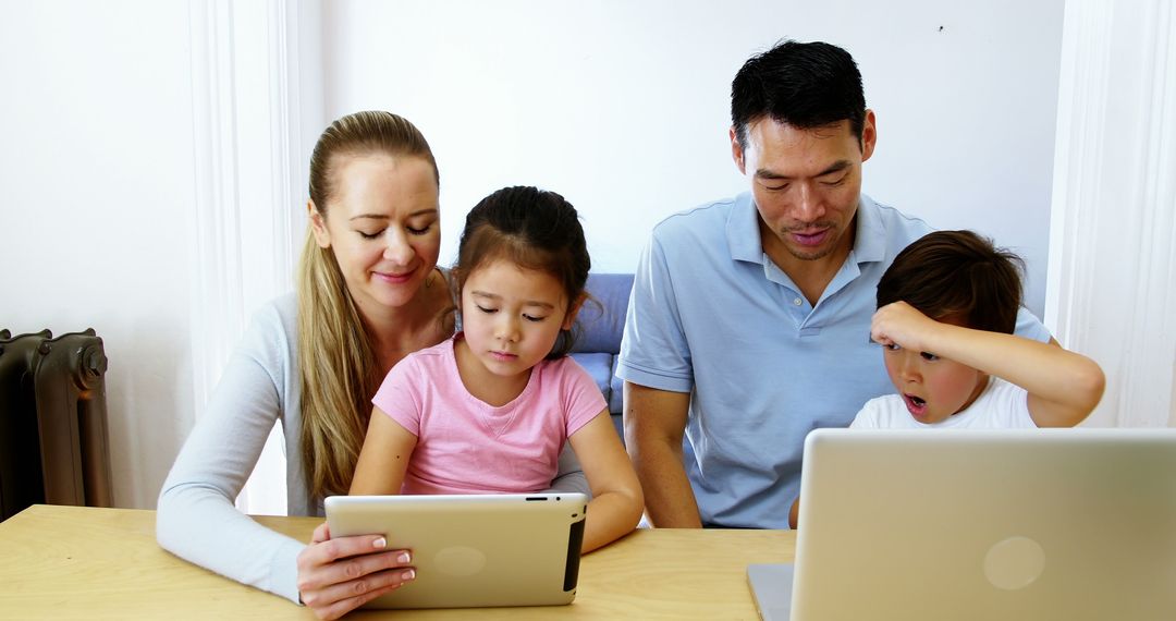 Parents and Children Using Tablets and Laptops at Home - Free Images, Stock Photos and Pictures on Pikwizard.com