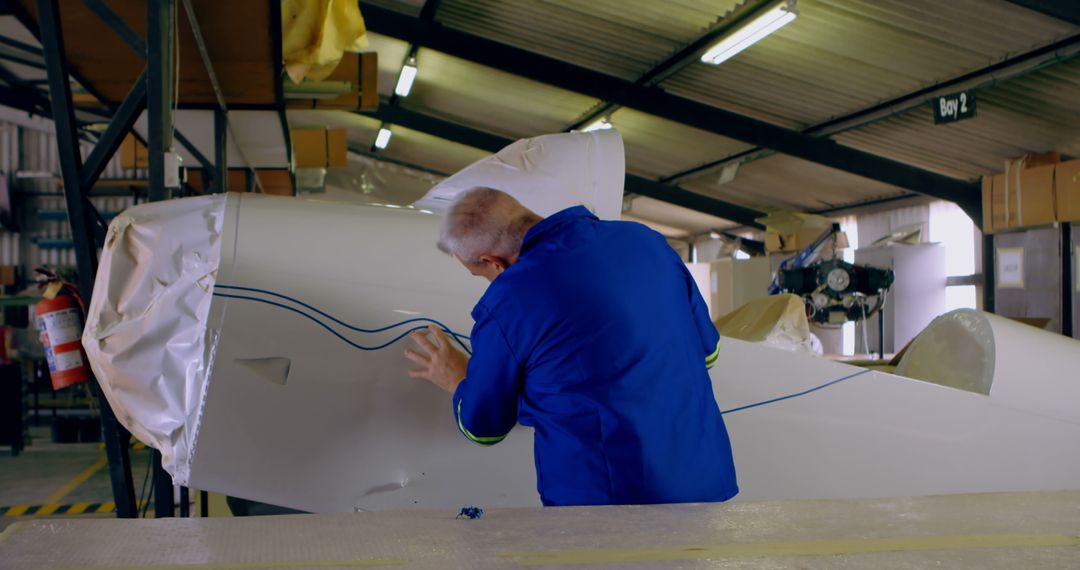 Engineer Working on Aircraft Maintenance in Workshop - Free Images, Stock Photos and Pictures on Pikwizard.com