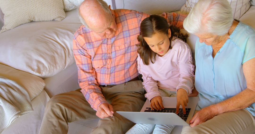 Grandparents and Granddaughter Using Laptop Together at Home - Free Images, Stock Photos and Pictures on Pikwizard.com