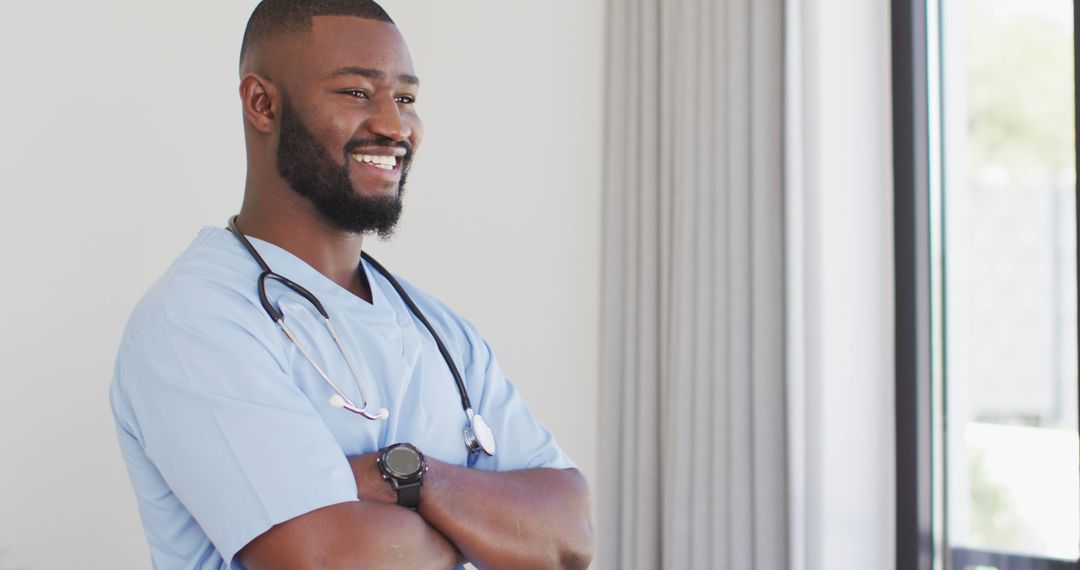 Confident African American Male Nurse in Medical Uniform Smiling Indoors - Free Images, Stock Photos and Pictures on Pikwizard.com