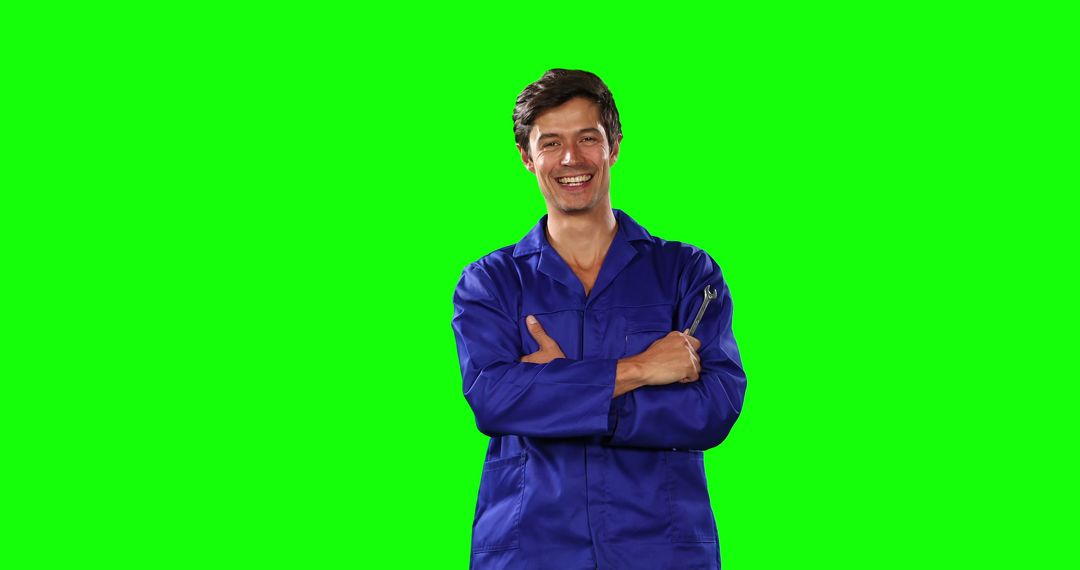 Smiling Male Mechanic Holding Tool on Green Screen Background - Free Images, Stock Photos and Pictures on Pikwizard.com