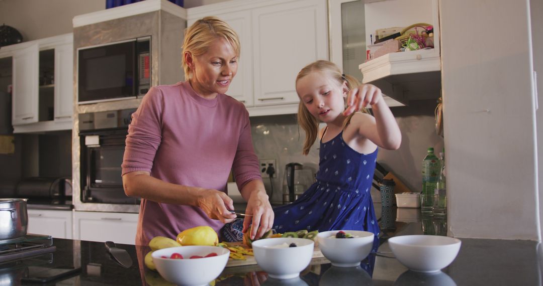 Mother and Daughter Preparing Healthy Meal in Modern Kitchen - Free Images, Stock Photos and Pictures on Pikwizard.com