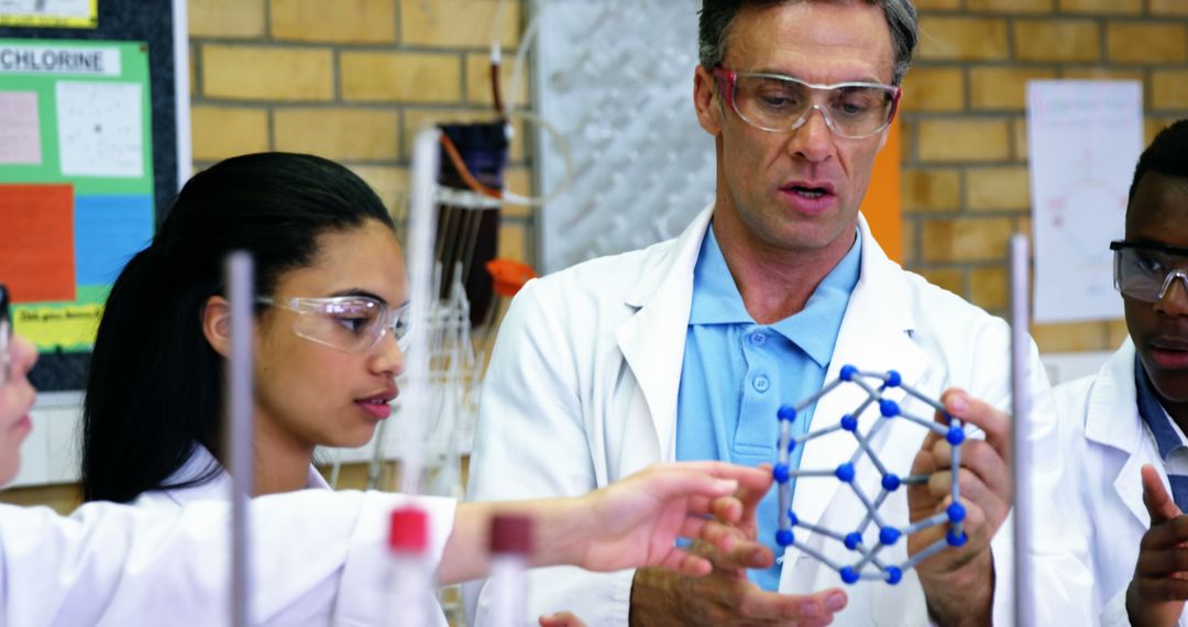 A teacher uses a molecular model to actively engage diverse students in a chemistry lesson. - Free Images, Stock Photos and Pictures on Pikwizard.com