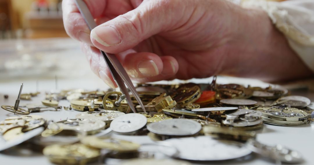 Horologist Carefully Handling Watch Parts with Precision in Workshop