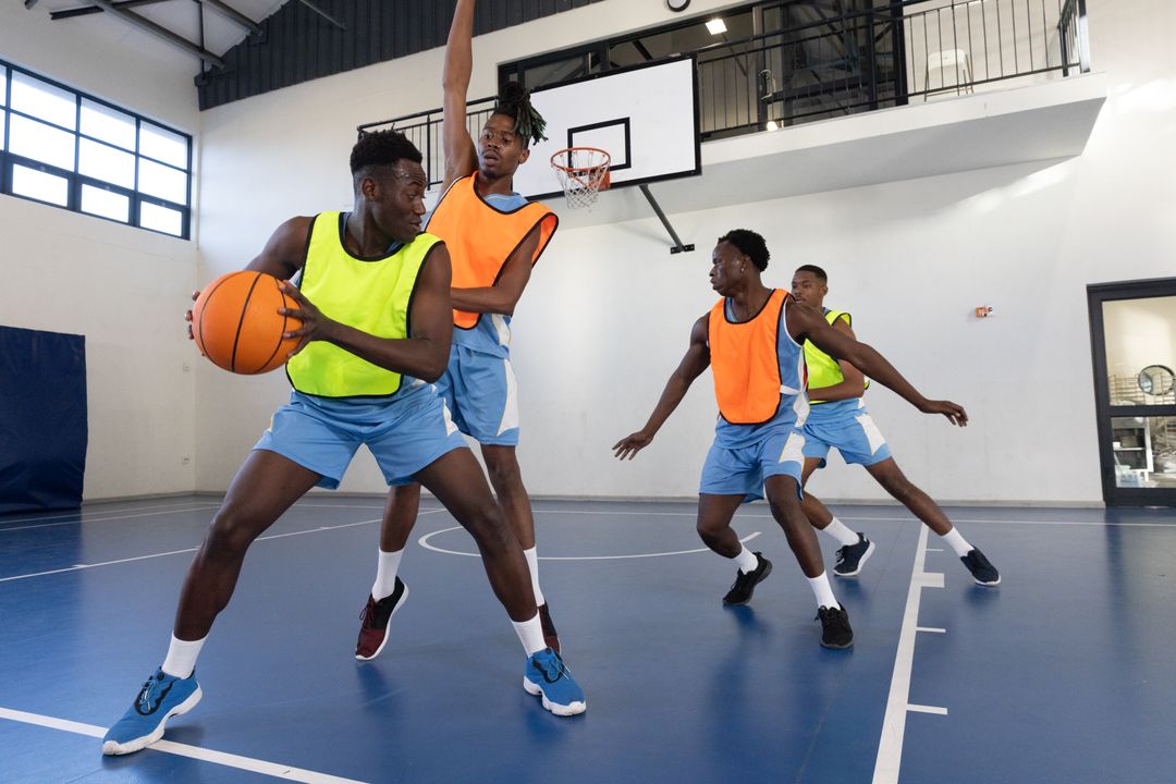 Basketball Players in Action Pivoting on Indoor Court