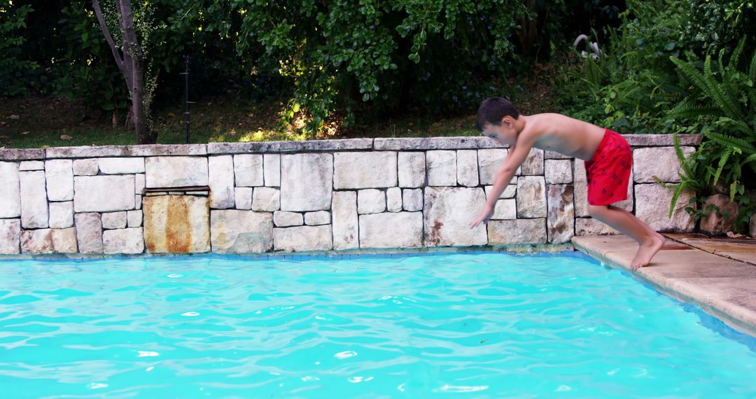 Young Boy Diving Into Swimming Pool on Sunny Day - Free Images, Stock Photos and Pictures on Pikwizard.com