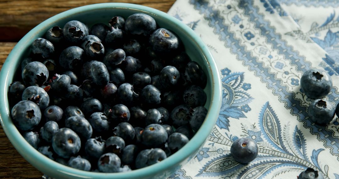 Fresh Blueberries in Ceramic Bowl on Decorative Fabric - Free Images, Stock Photos and Pictures on Pikwizard.com