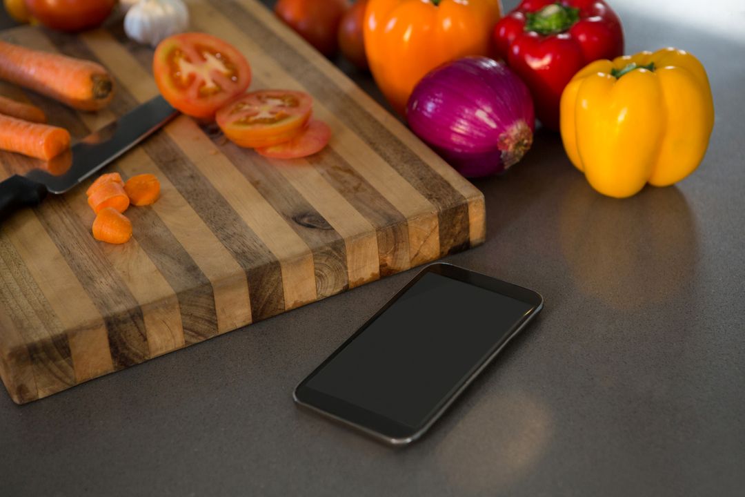 Smartphone on Kitchen Counter with Fresh Vegetables - Free Images, Stock Photos and Pictures on Pikwizard.com