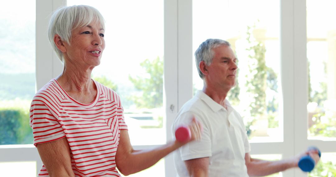 Senior Couple Exercising with Small Dumbbells in Bright Room