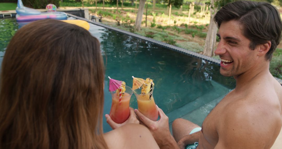 Couple Enjoying Tropical Cocktails in Infinity Pool - Free Images, Stock Photos and Pictures on Pikwizard.com