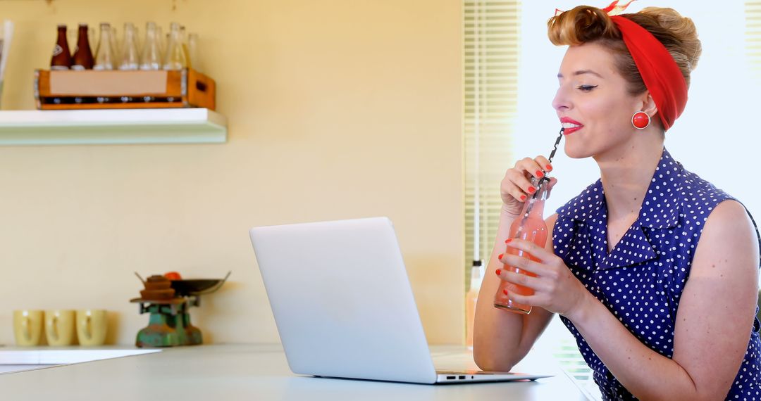 Vintage-styled woman drinking soda while using laptop - Free Images, Stock Photos and Pictures on Pikwizard.com