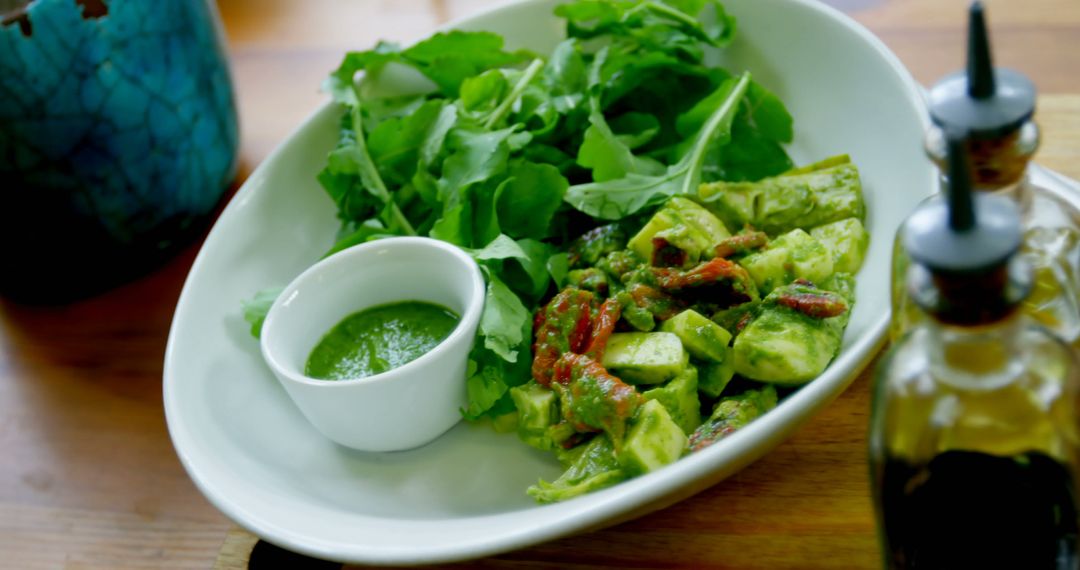 Fresh Vegetable Salad with Green Dressing on Wooden Table - Free Images, Stock Photos and Pictures on Pikwizard.com