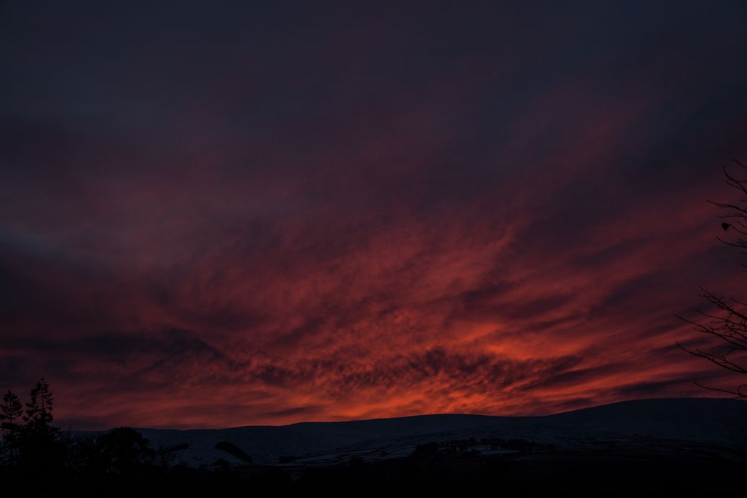 Dark Orange Sky with Fiery Sunset Over Distant Hills - Free Images, Stock Photos and Pictures on Pikwizard.com