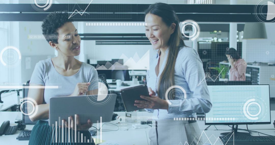 Diverse Colleagues Analyzing Data on Tablet in Modern Office