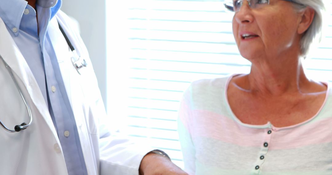 Doctor Discussing Medical Results with Elderly Woman - Free Images, Stock Photos and Pictures on Pikwizard.com