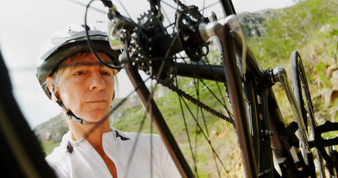 Cyclist Repairing Bicycle in Outdoor Setting - Free Images, Stock Photos and Pictures on Pikwizard.com