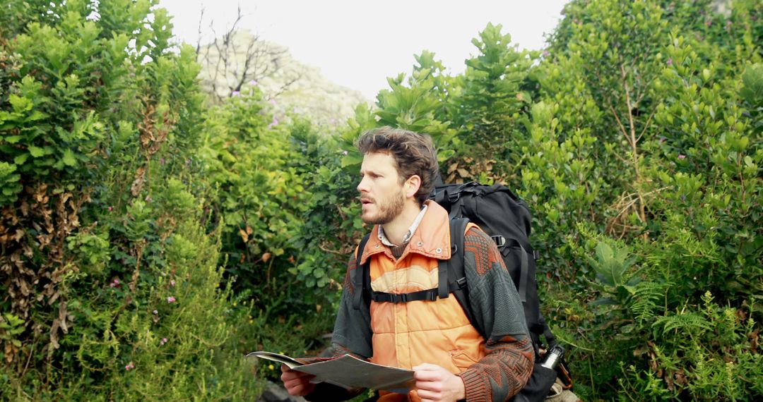 Hiker studying map on wilderness trail for adventure exploration
