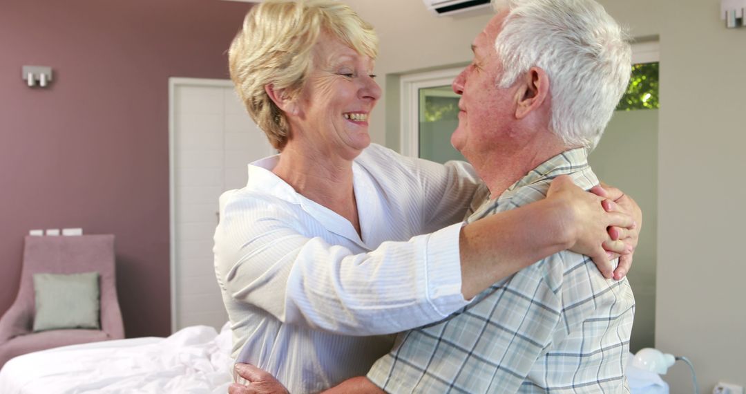 Happy Senior Couple Hugging in Modern Bedroom - Free Images, Stock Photos and Pictures on Pikwizard.com