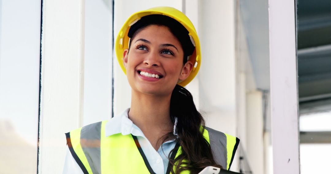 Smiling Female Construction Worker in Reflective Vest and Hard Hat - Free Images, Stock Photos and Pictures on Pikwizard.com