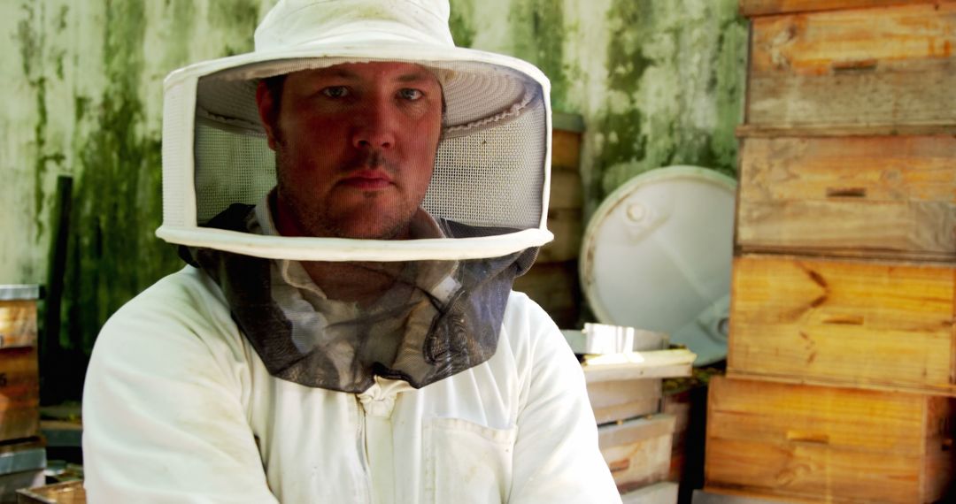 Confident Beekeeper in Protective Suit Standing in Apiary