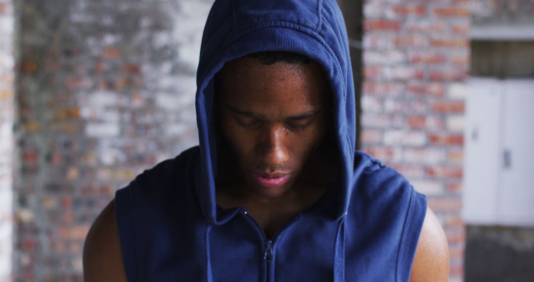 Sweaty African American man in a hoodie embodies urban fitness with a post-exercise gaze. - Free Images, Stock Photos and Pictures on Pikwizard.com