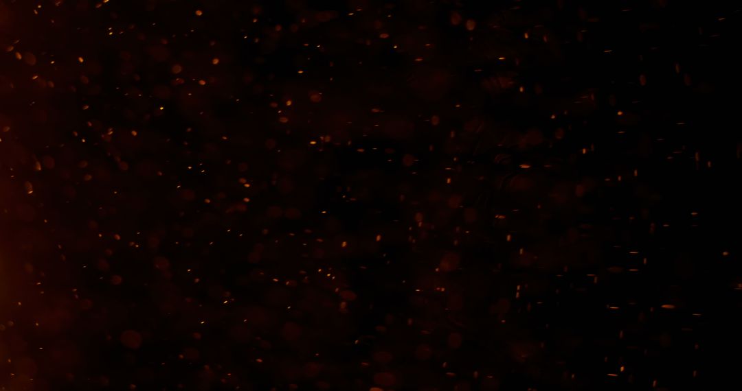 Glowing Sparks Against Dark Background Creating Cosmic Illusion
