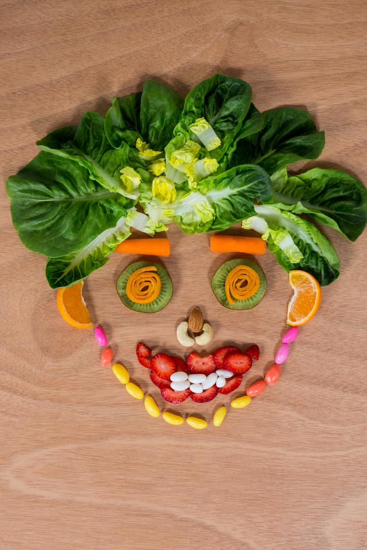 Creative Face Made of Vegetables and Confectionery on Wooden Table - Free Images, Stock Photos and Pictures on Pikwizard.com