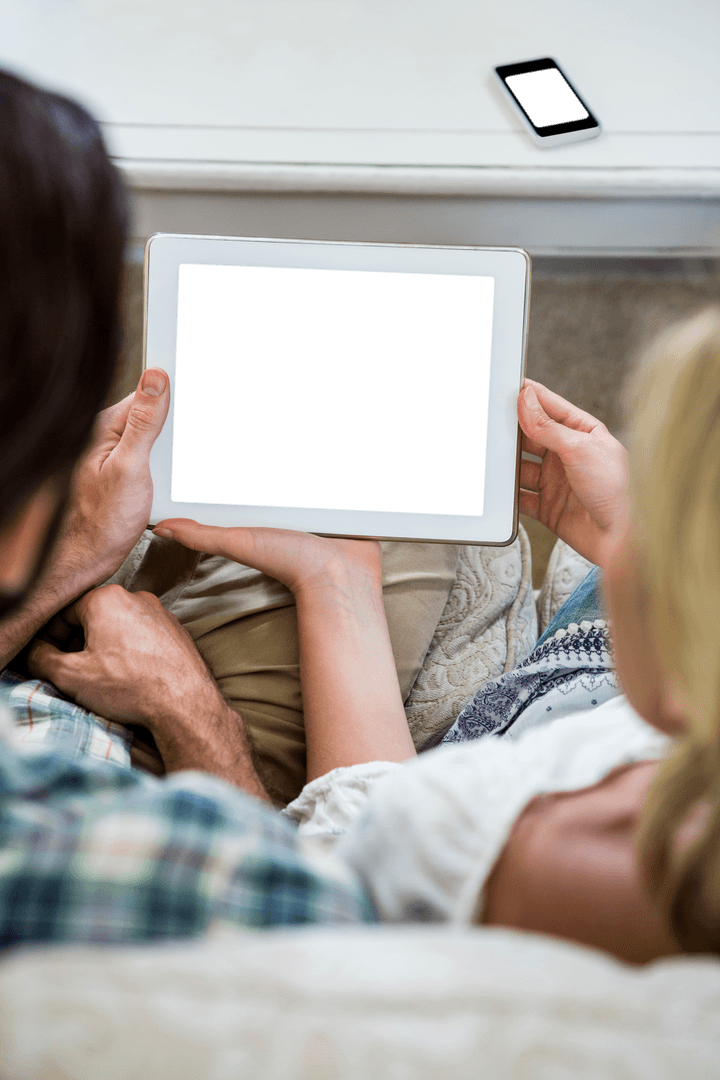 Couple Relaxing with Transparent Screen Digital Tablet at Home