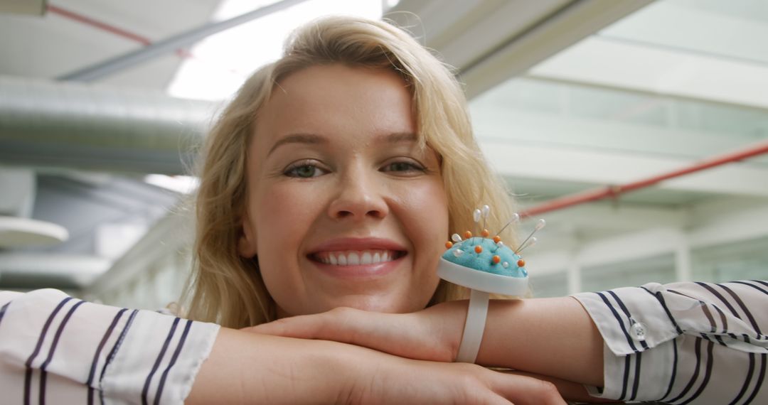 Smiling Woman with Pincushion Bracelet in Modern Office - Free Images, Stock Photos and Pictures on Pikwizard.com