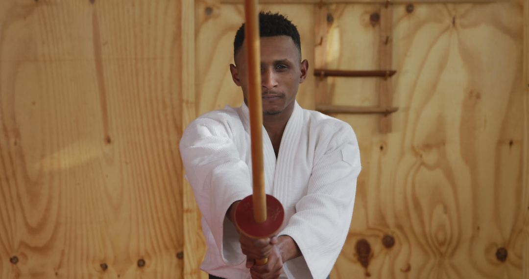 Young African Martial Artist Practicing with Wooden Katana - Free Images, Stock Photos and Pictures on Pikwizard.com