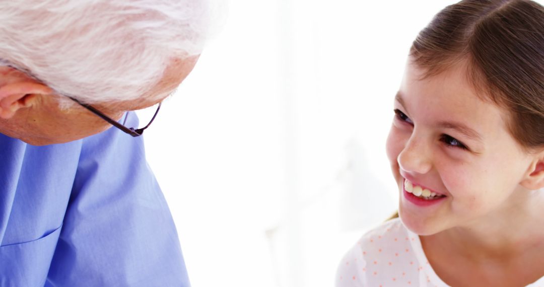 Grandfather And Granddaughter Smiling Together - Free Images, Stock Photos and Pictures on Pikwizard.com